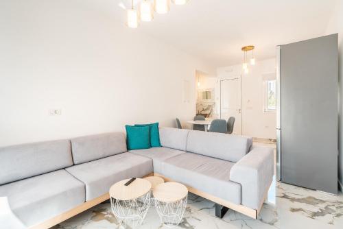 a living room with a couch and two tables at Punta Mare Villa 4 in Karpathos Town