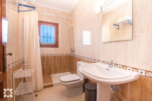 a bathroom with a sink and a toilet at Villa Octavio by Abahana Villas in Benitachell