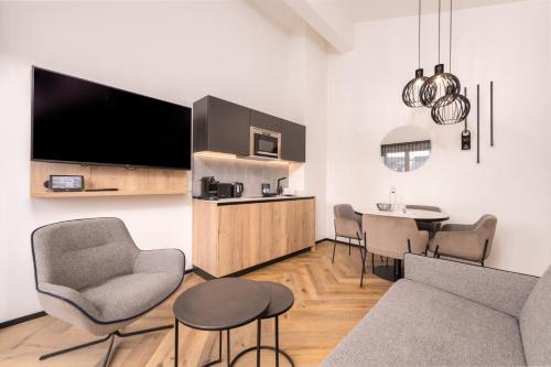 a living room with a couch and a table at The Gast House Zell am See in Zell am See