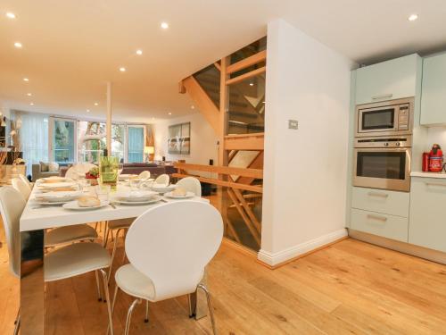 a kitchen and dining room with a table and chairs at 5 Red Sails in Poole