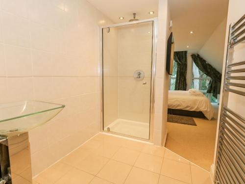 a bathroom with a shower and a sink at 5 Red Sails in Poole