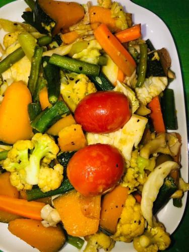 a plate of food with vegetables on a table at Lotus cool hotel and restaurant in Ibbagomuwa