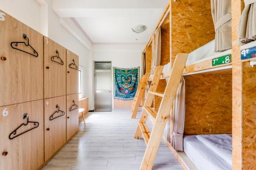 a room with two bunk beds and a staircase at Ocean Diary Hostel in Green Island