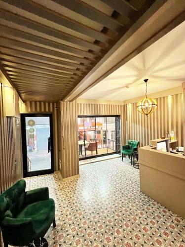 a lobby with wooden walls and green chairs and a desk at Taksim Cetinkaya Suite in Istanbul