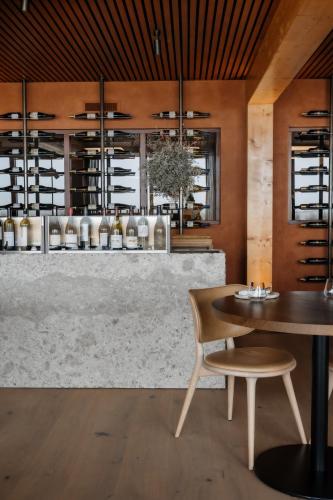 a dining room with a table and a counter at Strandhotel in Cadzand-Bad