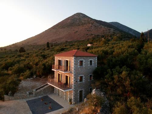 an aerial view of a house with a mountain in the background at Lithorama Residence Mani Complex in Koúmani