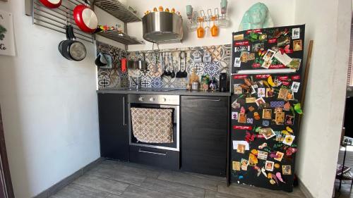 een keuken met een fornuis en een koelkast bedekt met magneten bij A casa di Roberto in Rome