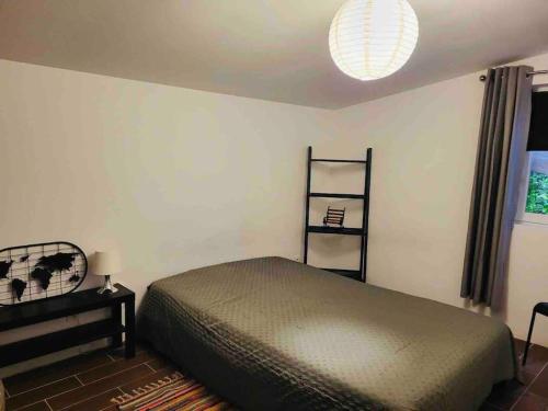 a bedroom with a bed and a shelf on the wall at La Madeleine,Agréable appartement au calme in Bergerac
