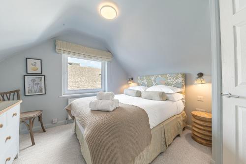 a bedroom with a large bed and a window at Cherry Garth HOT TUB HIRE AVAILABLE in Keswick