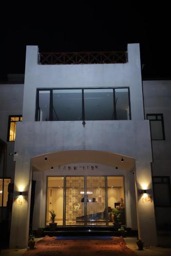 a large white building with a large window at Pink Villa Boutique Hotel in Meerut