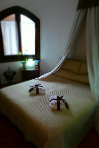 two towels sitting on top of a bed with a window at Castello in Valguarnera Caropepe