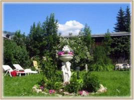 a flower planter in the middle of a yard at Apartment Grattschlössl in Sankt Johann in Tirol