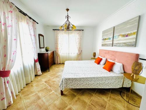 a bedroom with a bed with orange pillows at Finca Son Manxo (villas2meet Mallorca) in Manacor