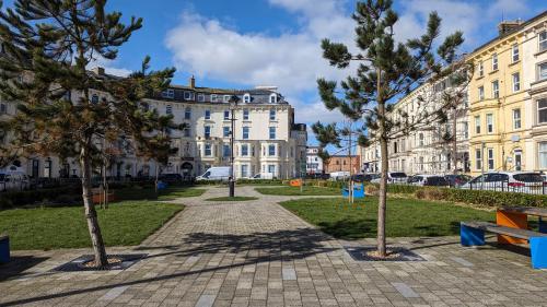 a park with trees in front of a building at Eden Apartments in Bridlington