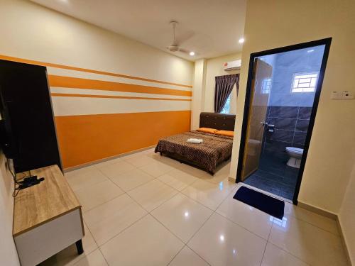a living room with a bed and a bathroom at The Blue Guest House, WiFi, Free Parking, Aulong in Taiping