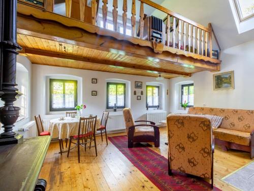 a living room with a table and chairs and a staircase at Holiday Home Horní Prysk by Interhome in Liberec