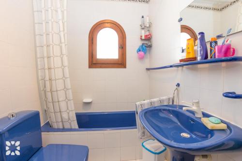 a bathroom with a blue sink and a toilet at Villa Nani by Abahana Villas in Calpe