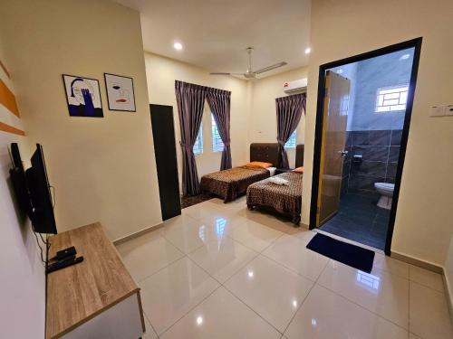 a living room with a large glass shower in a room at The Blue Guest House, Parking, Aulong in Taiping