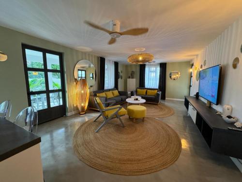 a living room with a couch and a table at Beautiful beach apartment in Flic-en-Flac