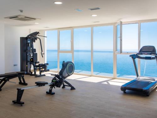 a gym with a view of the ocean at Apartment Bayview Hills by Interhome in Torrox Costa
