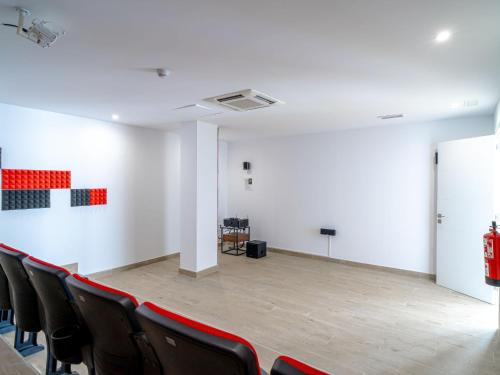 an empty room with black chairs and a white wall at Apartment Bayview Hills by Interhome in Torrox Costa