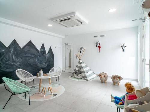 a room with chairs and tables and a painting on the wall at Apartment Bayview Hills by Interhome in Torrox Costa