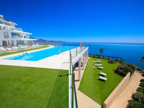 a view of a swimming pool and the ocean at Apartment Bayview Hills by Interhome in Torrox Costa