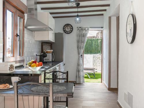 a kitchen with a table and chairs and a window at Holiday Home Mamasica by Interhome in Ingenio