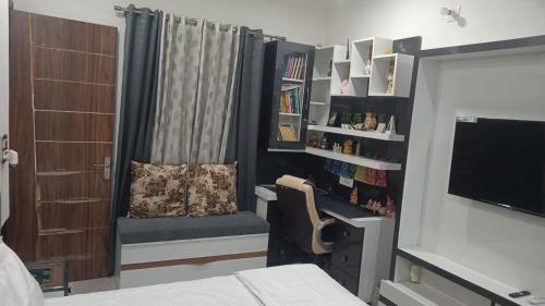 a bedroom with a bed and a chair and a book shelf at The Great Escape in Rāja Sānsi