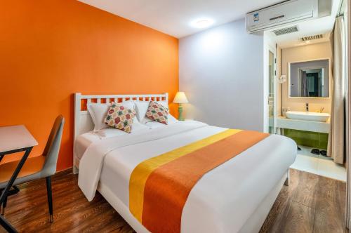 a bedroom with a bed and a bathroom with a sink at Xi'an See Tang Guesthouse in Xi'an