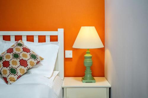 a lamp on a night stand next to a bed at Xi'an See Tang Guesthouse in Xi'an