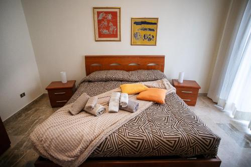 a bedroom with a bed with two towels and pillows at Monte camicia - cozy home in city center-spacious-free parking in LʼAquila