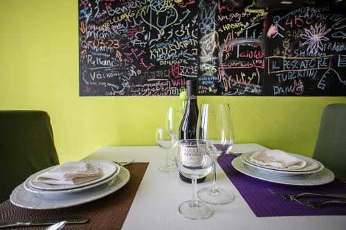 a table with plates and wine glasses on it at Monte camicia - cozy home in city center-spacious-free parking in LʼAquila
