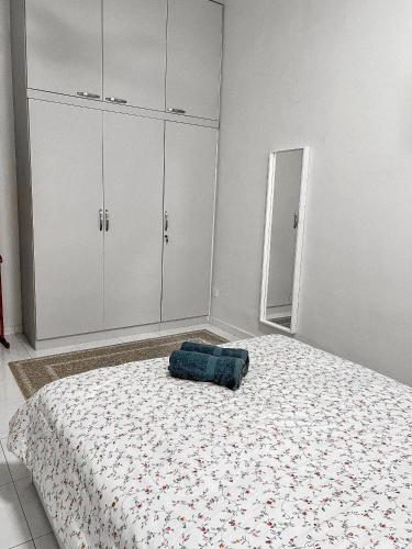 a bedroom with a bed with a blue pillow on it at Cahaya Melissa Homestay Private Pool in Melaka