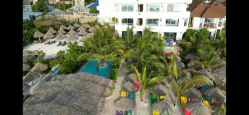 arial view of a resort with a pool and palm trees at SunSeaBar Beach Resort in Kendwa