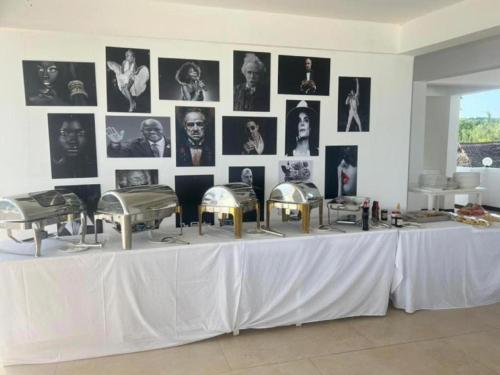 a white table with photos on a wall at SunSeaBar Beach Resort in Kendwa