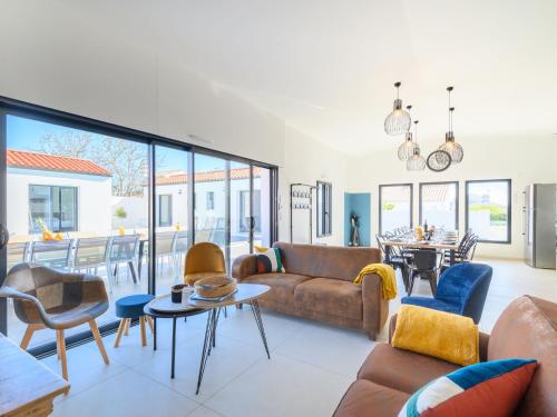 a living room with a couch and chairs and a table at Villa Charme de la Blancharderie by Interhome in Barbâtre
