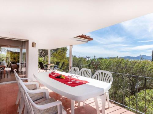 a white dining room with a white table and chairs at Holiday Home Tortuga by Interhome in Llança