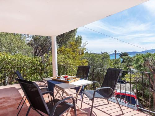 a patio with a table and chairs on a balcony at Holiday Home Tortuga by Interhome in Llança