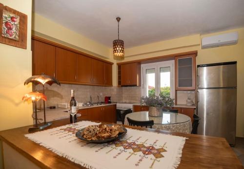a kitchen with a table with a plate of food on it at Μάνια in Pythagoreio