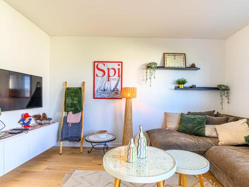 a living room with a couch and a table at Apartment Ty Breiz by Interhome in La Trinité-sur-Mer