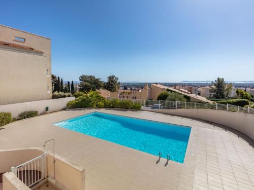 a swimming pool in the backyard of a house at Apartment Le Grand Large-2 by Interhome in Hyères