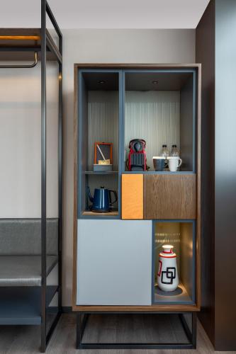 a room with a bunk bed and a shelf with food at UrCove by Hyatt Xi'an Hi-Tec in Xi'an