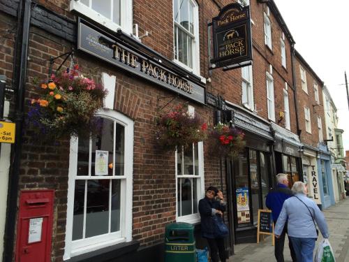 a group of people standing outside of a brick building at The Pack Horse in Louth