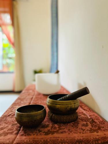 two bowls sitting on a table with a knife at One Bhakthi in Ahangama