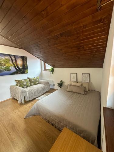 Chata Jana Dedinky في ديدينكي: غرفة نوم بسريرين وسقف خشبي