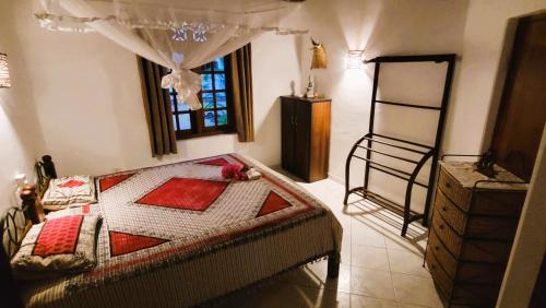 a bedroom with a bed and a ladder and a window at Czech House in Tangalle