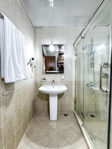 a bathroom with a sink and a shower at De Villa Hotel in Samarkand