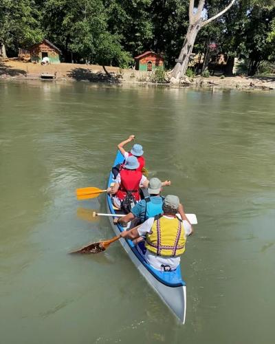 a group of people in a kayak on a river at Riverside Residence in Trstice