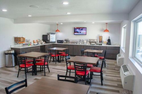 a restaurant with tables and chairs and a counter at Comfort Inn Battle Mountain in Battle Mountain